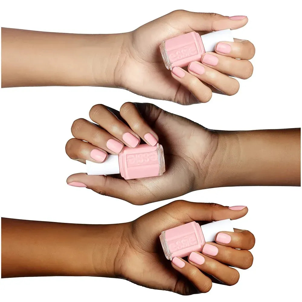Three polished hands holding pink nail color
